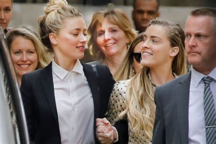 Do Amber Heard and Whitney Heard have the same parents?